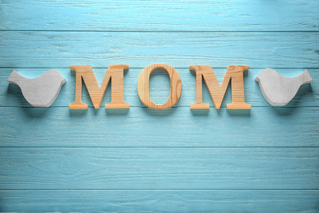 Word "Mom" on color wooden background. Mother's Day compositionの写真素材
