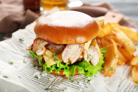 Tasty double burger on newspaper, closeupの写真素材