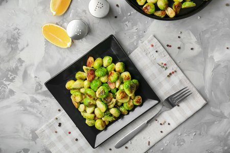 Plate with roasted brussel sprouts on tableの写真素材