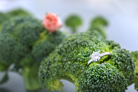Close up view of engagement ring on green broccoliの写真素材