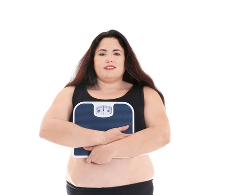 Overweight woman holding scales on white backgroundの写真素材