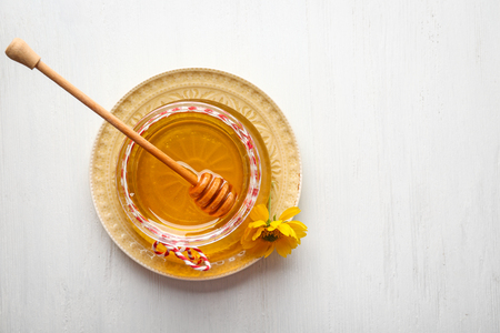 Aromatic honey in jar on tableの写真素材