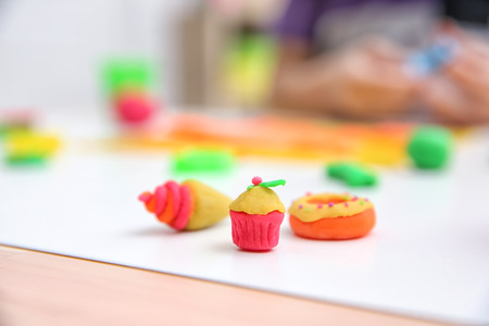 Cupcake made from playdough on table against blurred backgroundの写真素材