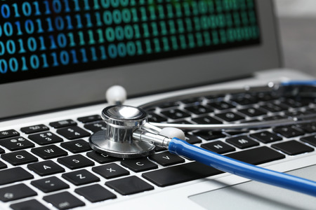 Stethoscope on laptop keyboard, closeup