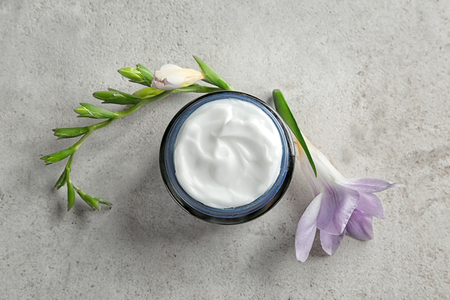 Jar of body cream on table