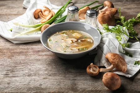 Bowl of delicious shiitake mushroom soup on tableの写真素材