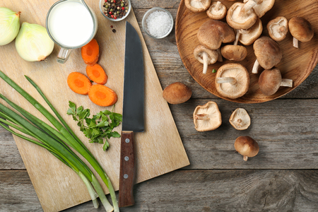 Composition with raw shiitake mushrooms and vegetables on tableの写真素材