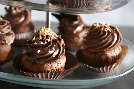 Dessert stand with tasty chocolate cupcakes, closeup