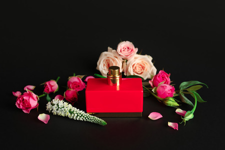 Bottle of perfume with flowers on dark backgroundの写真素材