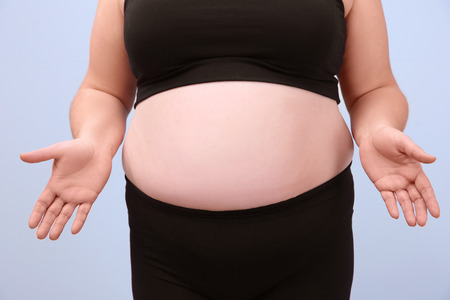 Overweight woman in underwear on light backgroundの写真素材