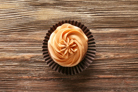 Tasty chocolate cupcake on wooden backgroundの写真素材
