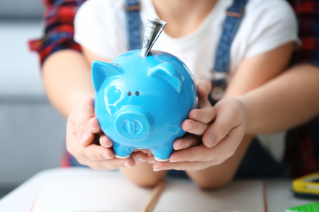 Mother and her little daughter holding piggy bank, closeupの写真素材