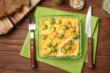 Baking dish with Brussels sprouts and cheese on tableの写真素材
