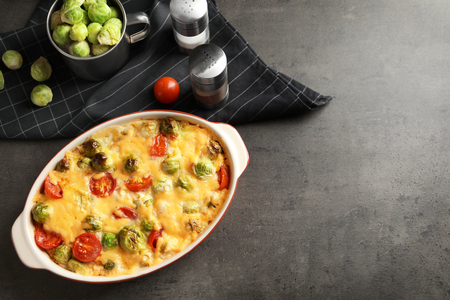 Baking dish with yummy brussel sprouts casserole on tableの写真素材