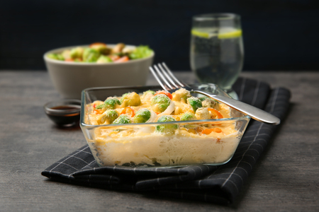 Baking dish with Brussels sprouts and cheese on tableの写真素材