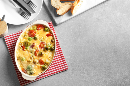 Baking dish with yummy brussel sprouts casserole on tableの写真素材