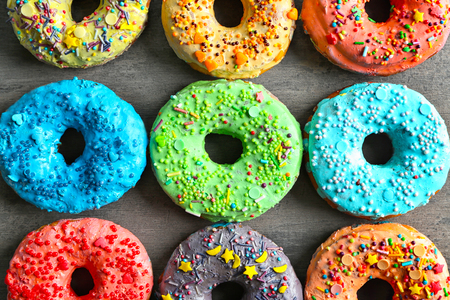 Fresh yummy colorful donuts on grey backgroundの写真素材