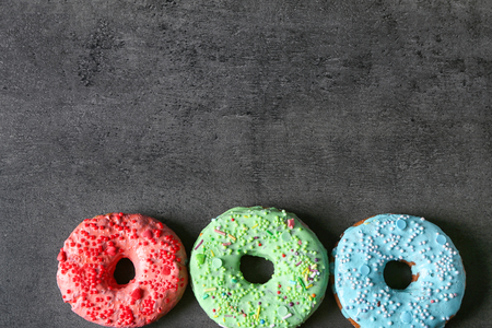 Fresh yummy colorful donuts on grey backgroundの写真素材