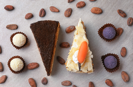 Pieces of tasty cakes and candies on grey backgroundの写真素材