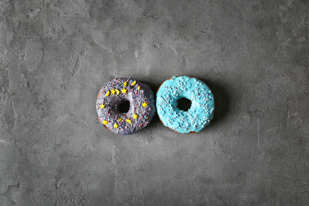 Fresh yummy colorful donuts on grey backgroundの写真素材