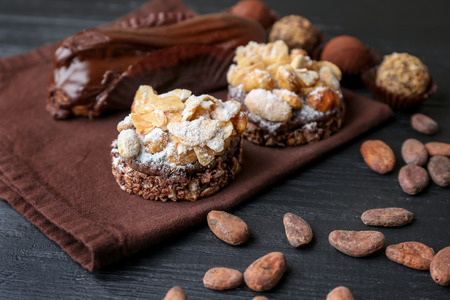 Variety of tasty sweets on wooden background