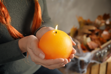 Woman holding burning candle. Halloween conceptの写真素材