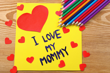 Cute handmade card with text I LOVE MY MOMMY on wooden table. Mother's day celebrationの写真素材