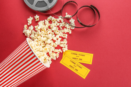 Composition with popcorn, film and cinema tickets on color backgroundの写真素材