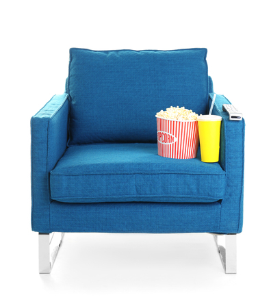 Cinema armchair with popcorn, soda and remote control, isolated on whiteの写真素材