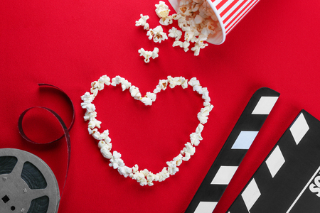 Composition with popcorn and cinema film on color backgroundの写真素材