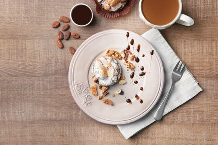 Plate with tasty praline cake on tableの写真素材