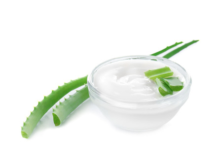 Bowl with body cream and aloe leaves on white backgroundの写真素材