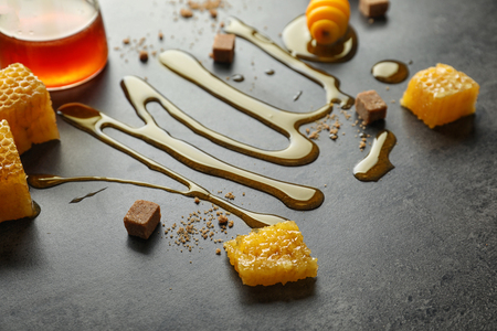 Composition with sweet honey on grey backgroundの写真素材