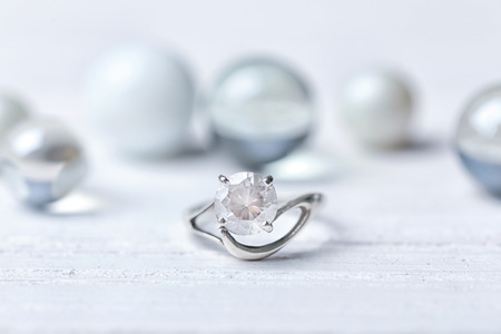 Beautiful engagement ring on light table, closeupの写真素材