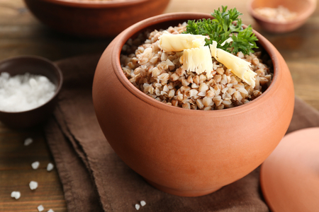 Pot with cooked buckwheat on tableの写真素材