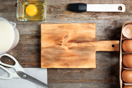 Kitchen utensils and ingredients for pastries on wooden backgroundの写真素材