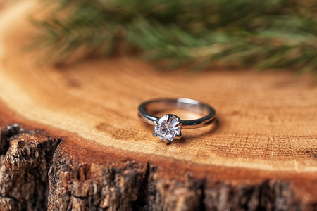 Engagement ring on tree stump, closeupの写真素材