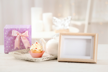 Frame, gift box and tasty breakfast for Mother's day on tableの写真素材