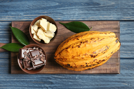 Composition with cocoa pod on wooden background, top viewの写真素材