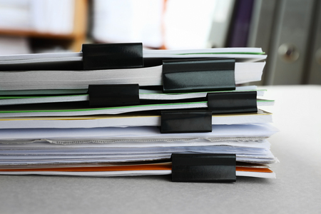 Stack of folders with documents on table in archive