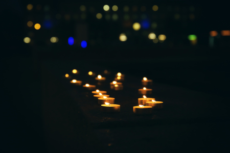 Lots of burning candles in darknessの写真素材