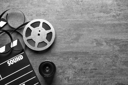 Movie clapper and reel on grey background, top viewの写真素材