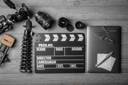 Composition with movie clapper, laptop and different lenses on grey background, top viewの写真素材