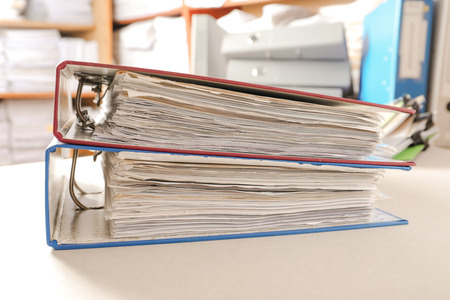 Folders with documents on table in archive