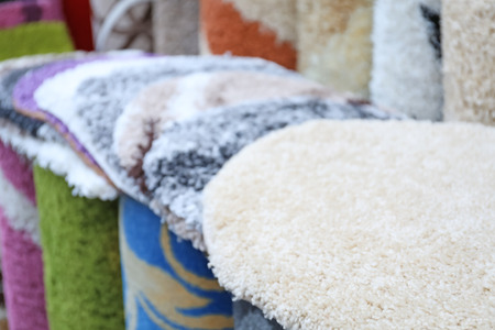 Many carpets of different colors in storeの写真素材