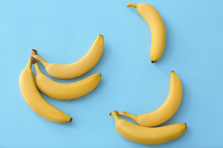 Tasty ripe bananas on color backgroundの写真素材