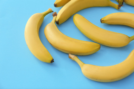 Tasty ripe bananas on color backgroundの写真素材