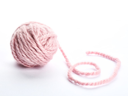 Pink yarn ball on white backgroundの写真素材