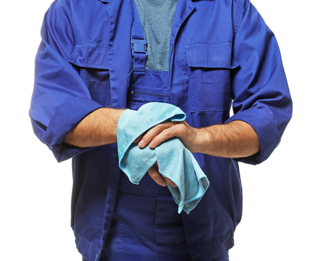 Auto mechanic wiping hands on white background, closeupの写真素材