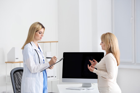 Female doctor consulting patient in clinicの写真素材